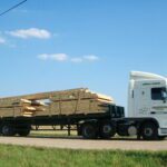 40 FT FLATBED TRAILER WITH ANDERSONS LOGO AND WOOD LOAD