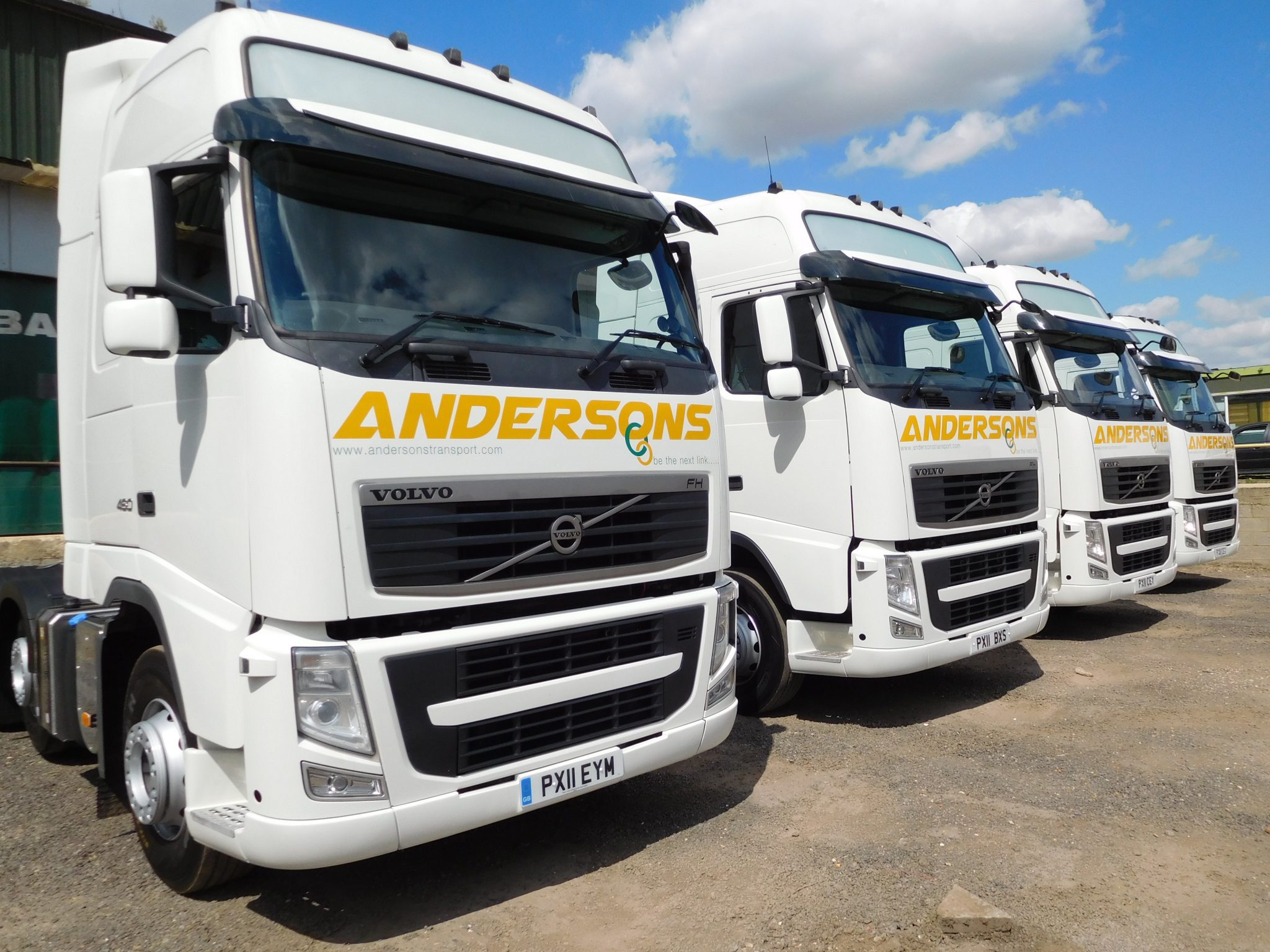 ANDERSONS VOLVO FH12 Trucks in a row in front of loading bays